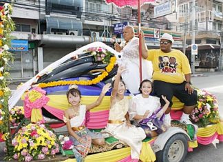 Man arrives for monk ordination on jet ski, accompanied by band, girls Satit Puakpong arrives on his chariot en route to ordaining as a novice monk.
